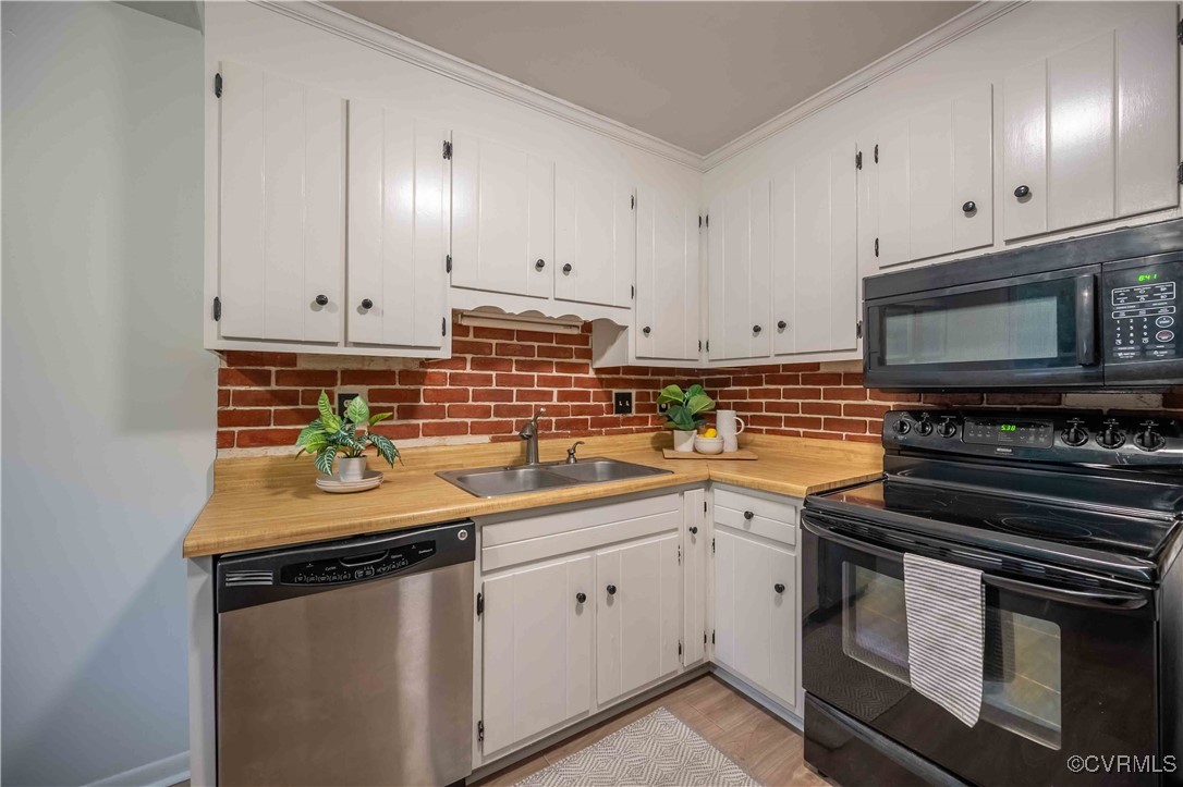 10313 Natural Bridge Road North Chesterfield, VA 23236 - Photo 12 of 31 a kitchen with stainless steel appliances granite countertop a sink stove oven and white cabinets