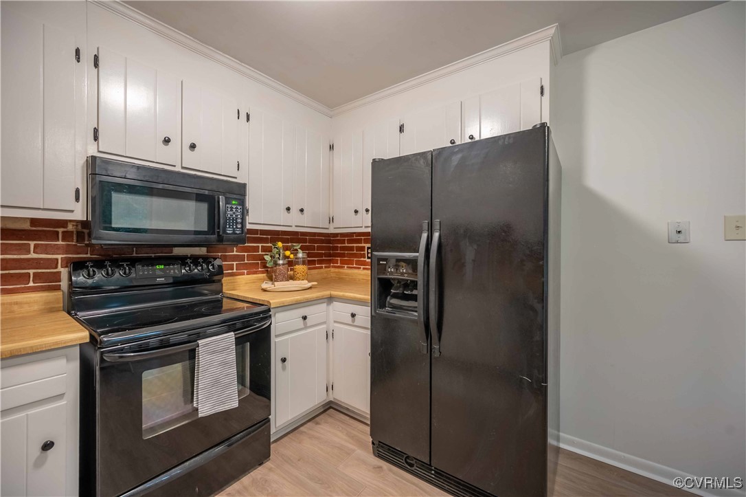 10313 Natural Bridge Road North Chesterfield, VA 23236 - Photo 13 of 31 a kitchen with a refrigerator stove and microwave