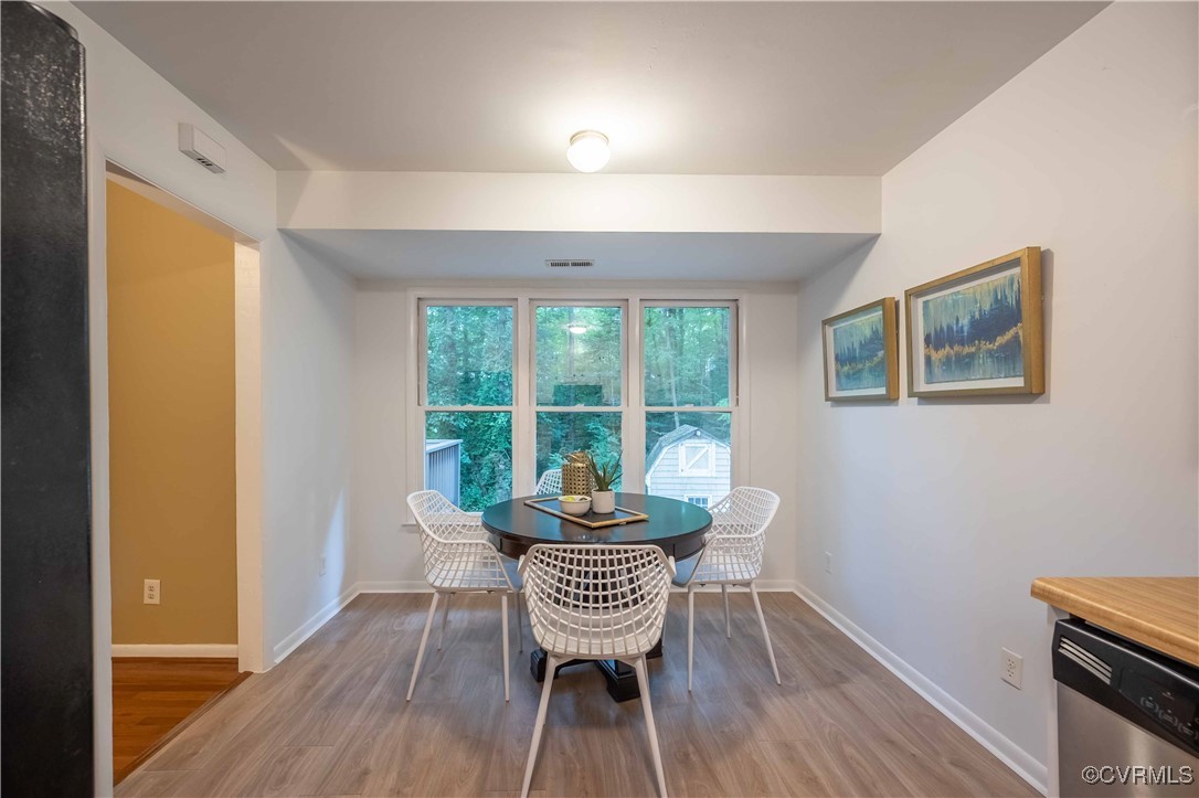 10313 Natural Bridge Road North Chesterfield, VA 23236 - Photo 14 of 31 a view of a dining room with furniture window and wooden floor