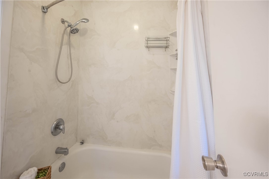 10313 Natural Bridge Road North Chesterfield, VA 23236 - Photo 20 of 31 a bathroom with a bath tub with a shower