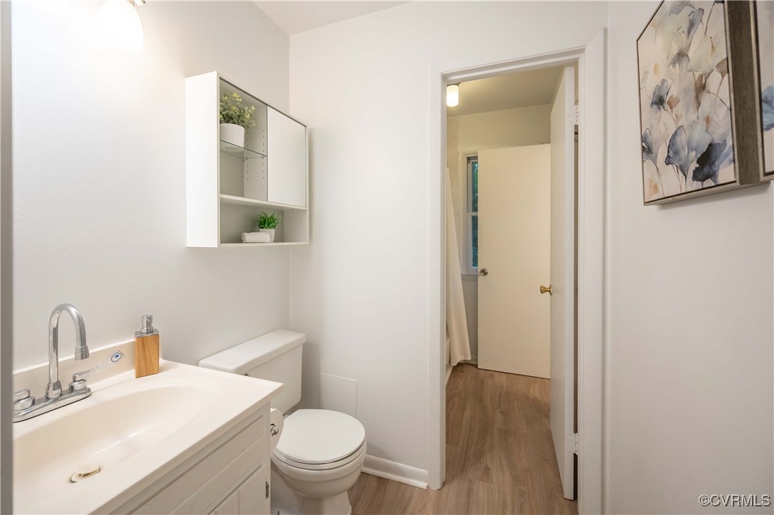 10313 Natural Bridge Road North Chesterfield, VA 23236 - Photo 21 of 31 a bathroom with a toilet a sink and mirror
