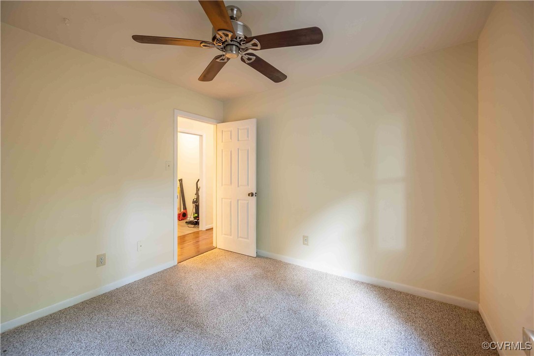 10313 Natural Bridge Road North Chesterfield, VA 23236 - Photo 23 of 31 an empty room and a chandelier fan