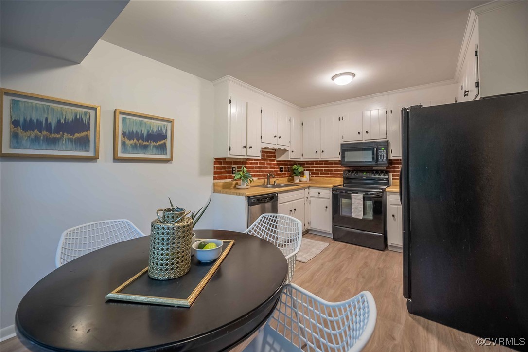 10313 Natural Bridge Road North Chesterfield, VA 23236 - Photo 10 of 31 a kitchen with stainless steel appliances granite countertop a dining table and chairs