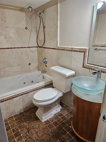 a bathroom with a toilet sink and shower