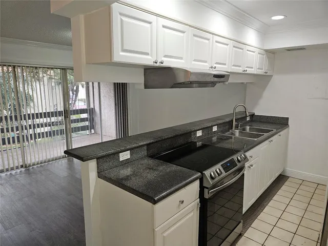 a kitchen with a sink and cabinets
