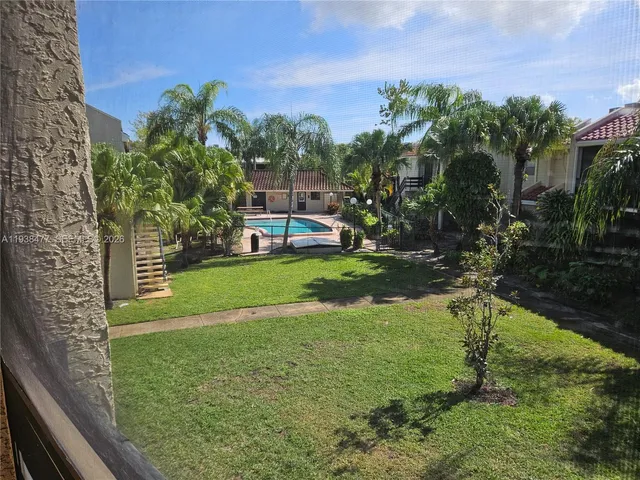 a view of a park with large trees