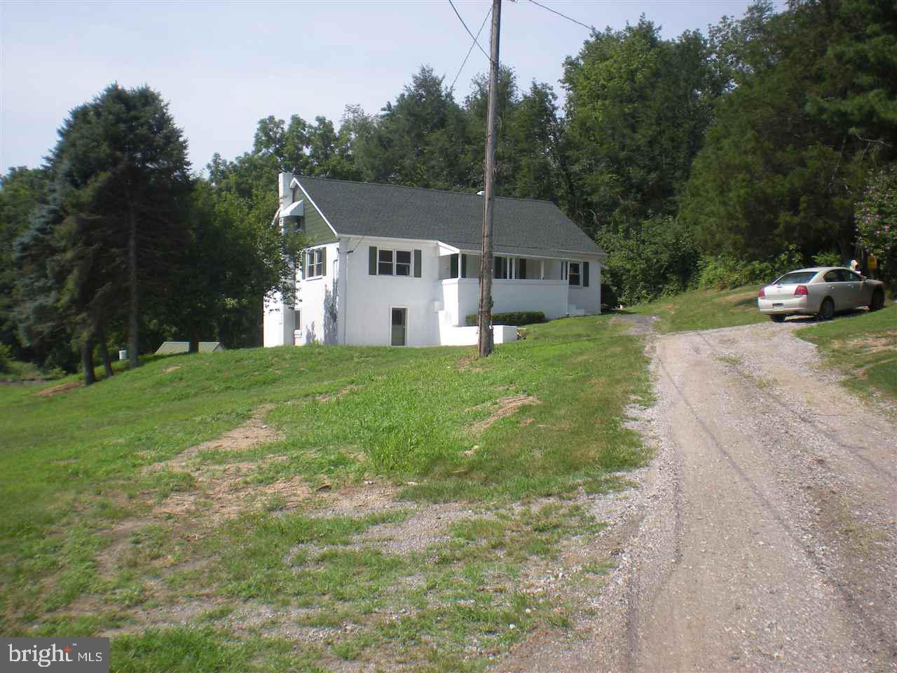 1588 Trolley Road Hanover, PA 17331 - Photo 1 of 31 a front view of a house with a yard and trees
