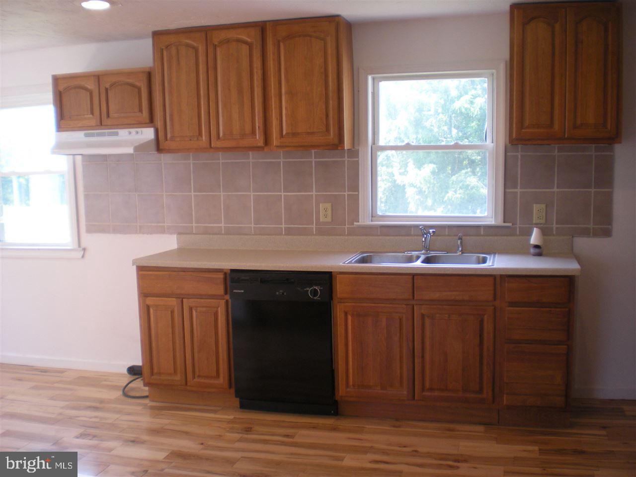 1588 Trolley Road Hanover, PA 17331 - Photo 11 of 31 a kitchen with granite countertop a sink cabinets and a wooden floor