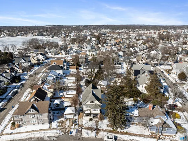an aerial view of residential houses with city view