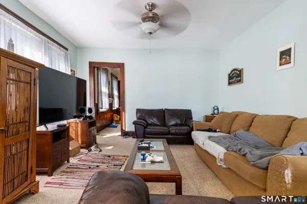 a living room with furniture a rug and a window