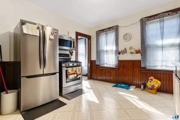 a bedroom with bed and a flat tv screen