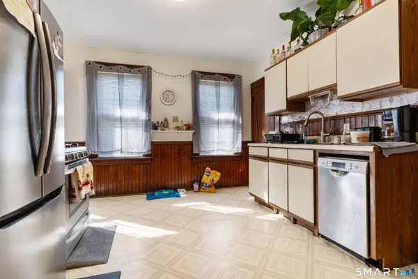 a kitchen with stainless steel appliances granite countertop a refrigerator and a sink