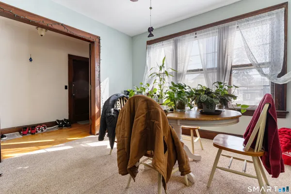 a kitchen with stainless steel appliances granite countertop a refrigerator a sink dishwasher and white cabinets with wooden floor