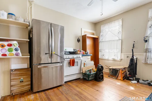 a kitchen with stainless steel appliances granite countertop a stove a refrigerator and a sink
