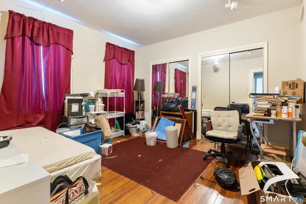 a kitchen with stainless steel appliances a refrigerator stove and wooden floor