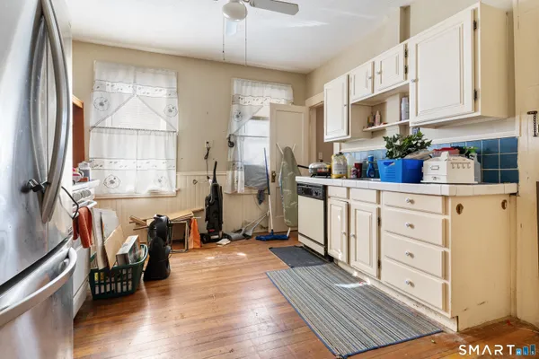 a bedroom with bed and wooden floor