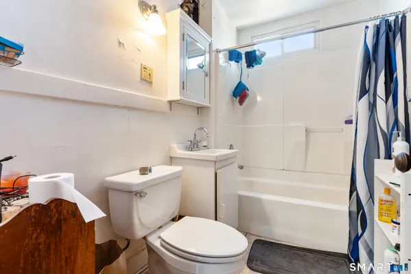 a kitchen with white cabinets and wooden floor