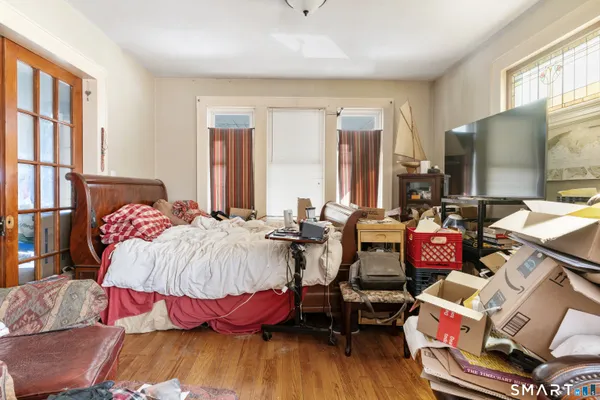 a dining room with furniture and a floor to ceiling window