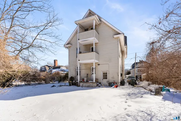 a bed room with a bed and a chair
