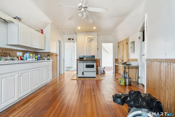a kitchen with a refrigerator and white cabinets