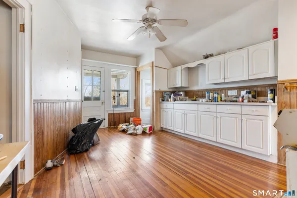 a kitchen with stainless steel appliances a lot of counter space and wooden floors