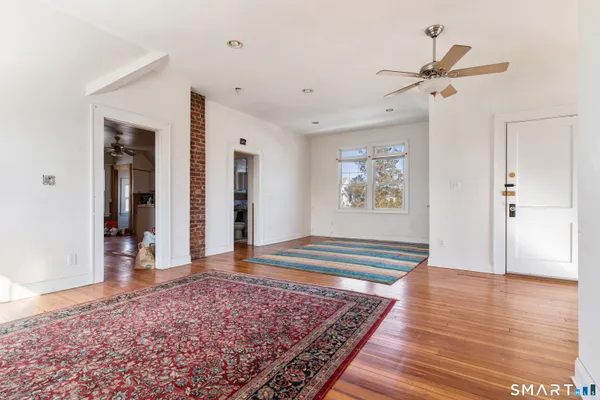 a view of empty room with wooden floor