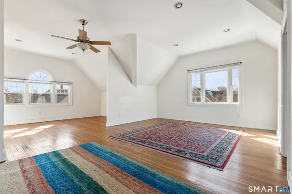 a living room with wooden floor furniture and a rug