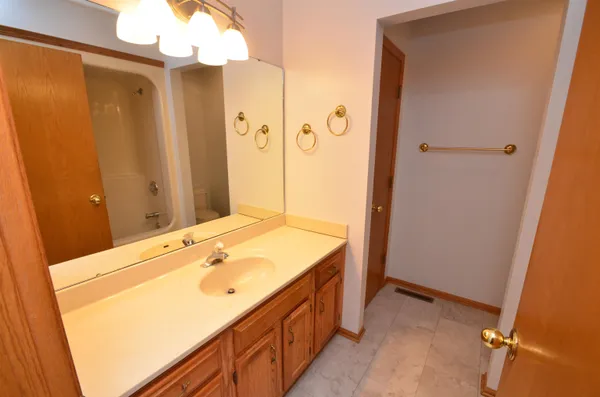 a white toilet sitting next to a shower