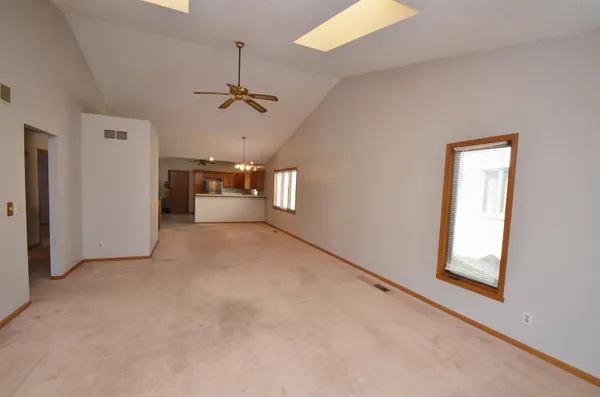 a large kitchen with a sink window and stainless steel appliances