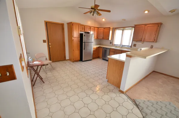 a kitchen with stainless steel appliances a refrigerator sink and microwave