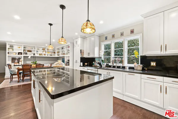 a living room with furniture and a book shelf