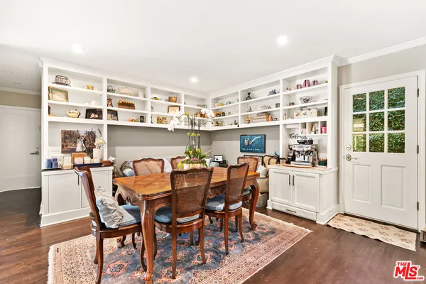 a living room with furniture fireplace and a large window
