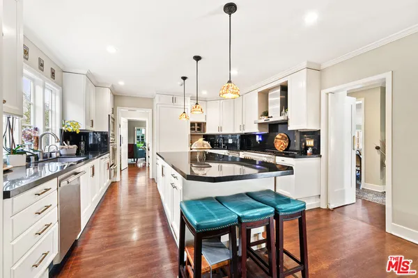 a room with furniture pool table and windows