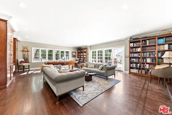 a view of a hallway with wooden floor and dining room