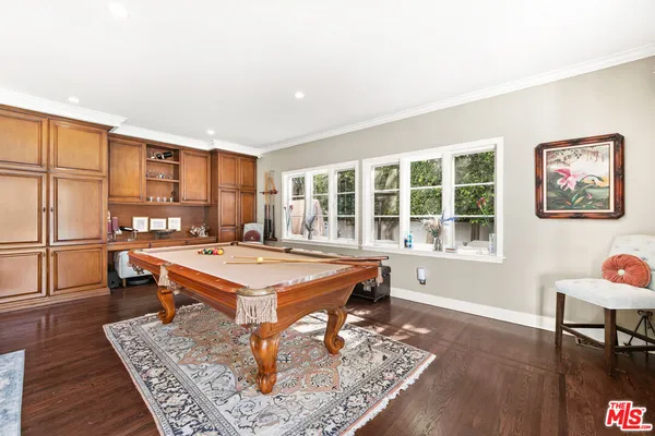 a view of a hallway with wooden floor and closet