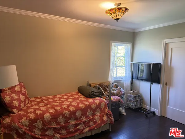 a bedroom with a bed a couch and a window