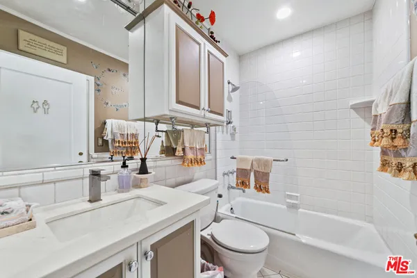 a en suite bathroom with a white tub and a shower
