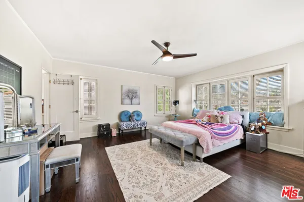 a bedroom with furniture and a wooden floor