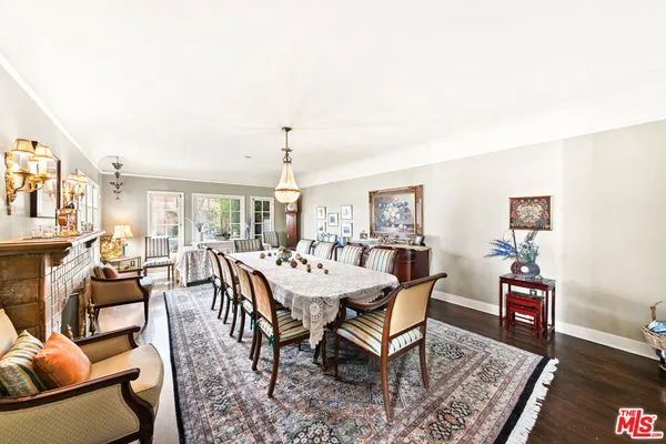 a living room with furniture fireplace and a large window