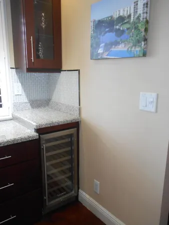 a kitchen with granite countertop a stove a sink and a dining table