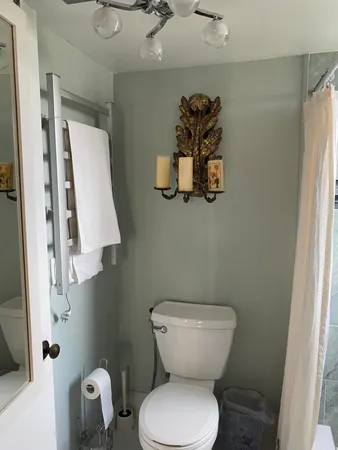 a bathroom with a granite countertop shower a mirror and window
