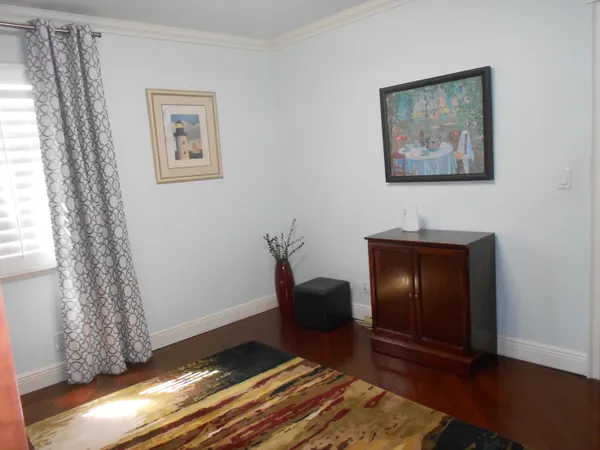 a living room with a furniture and a dresser