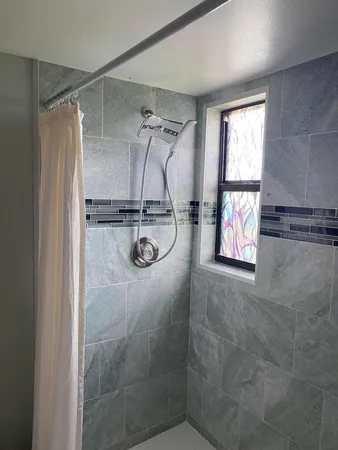 a bedroom with a large bed and wooden floor