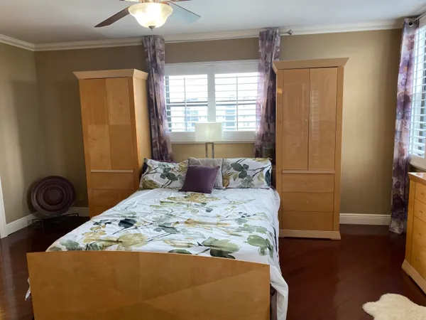 a bedroom with a bed and a window