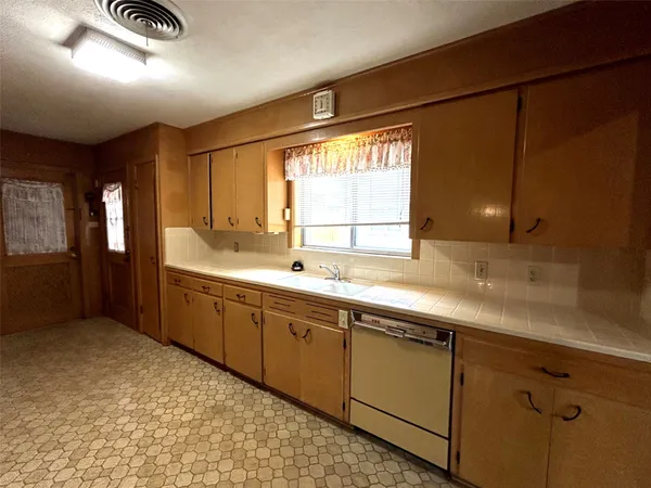 a large bathroom with a sink and a large mirror