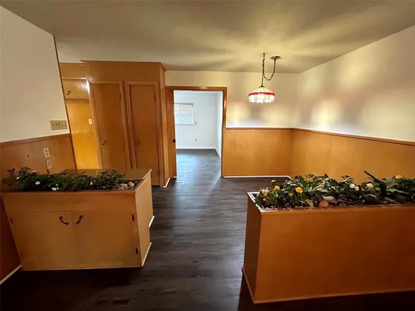 a view of a room with wooden floor and window