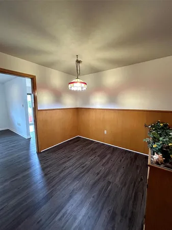 an empty room with wooden floor
