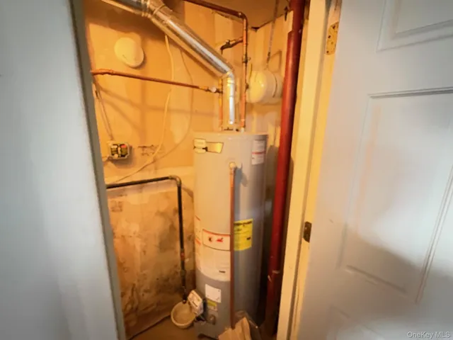 a bathroom with a granite countertop shower and a mirror