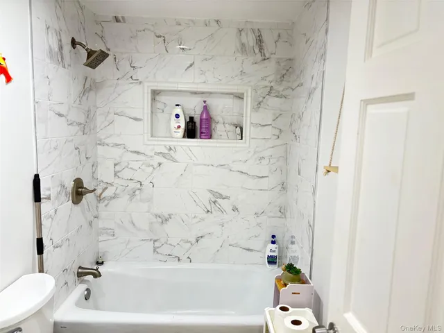 a bathroom with a bathtub and shower