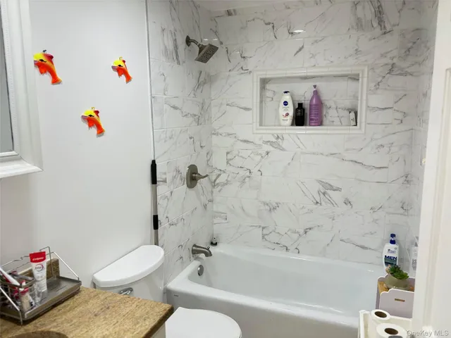 a bathroom with a bath tub a sink and a toilet